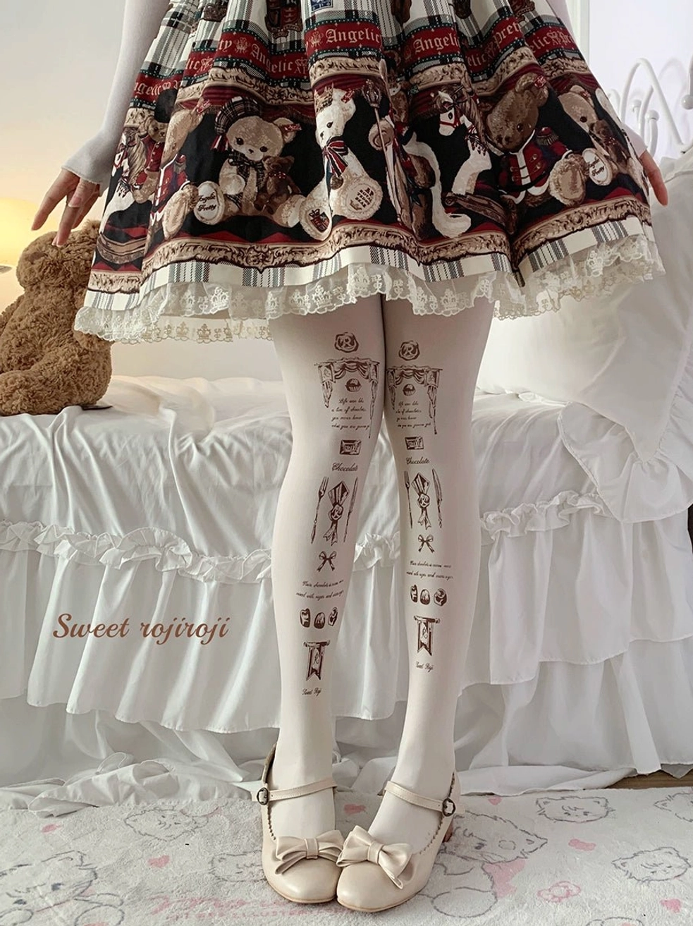 White velvet tattoo print lolita stockings front view on model wearing bear print lolita dress with bow mary jane shoes bedroom setting