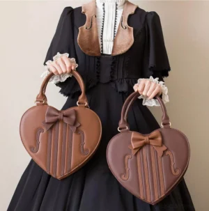 Violin heart-shaped lolita handbag in brown and white with bow detail held by model wearing black gothic lolita dress with violin collar ornament