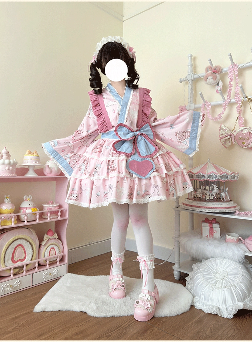 Beautiful wa lolita kawaii dress ensemble three-quarter standing view, model spreading generous kimono sleeves to showcase silhouette, charming bear and dessert motifs, heart-shaped chest decoration bow