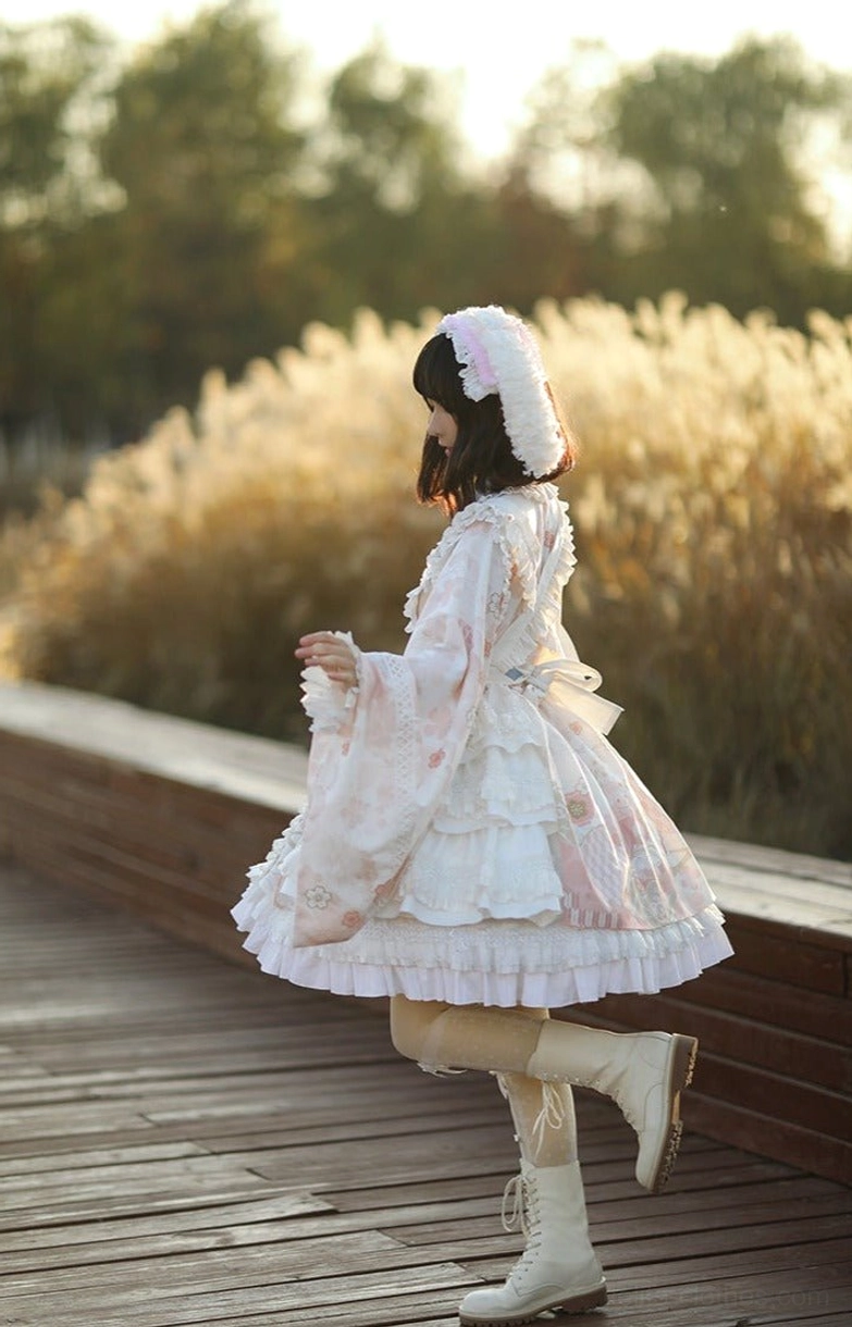 All-white kimono-style Wa Lolita OP dress with multi-layered ruffled skirt, side back partial view of model walking on wooden boardwalk, lace-trimmed wide sleeves with furry hooded headwear
