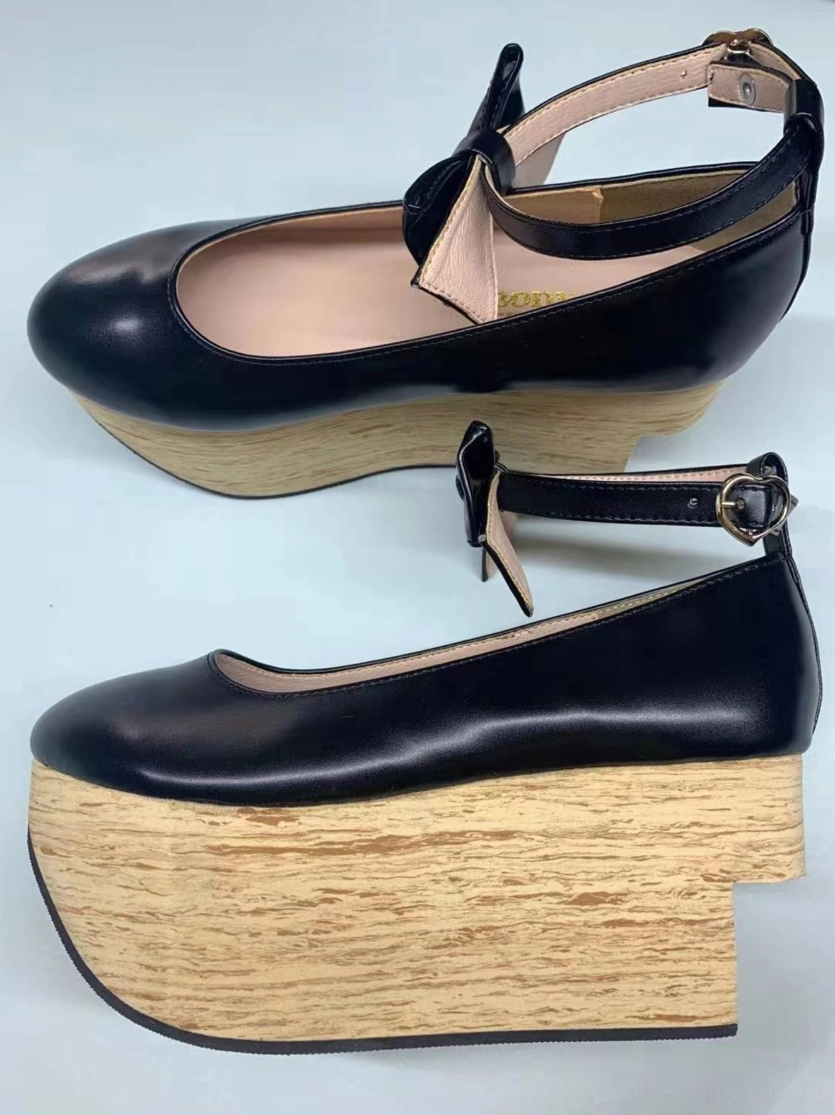 Black glossy patent leather wa lolita platform Mary Jane shoes with dual adjustable ankle buckle straps, round toe, authentic wood-grain wedge platform heel, shown in pair flat lay and single shoe profile on plain light blue background