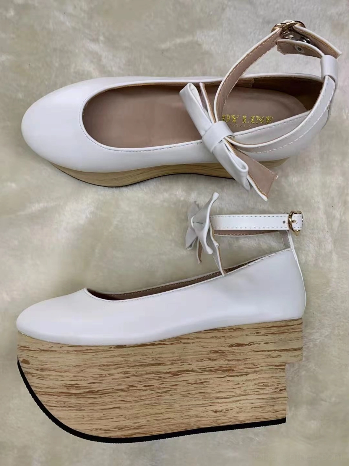 White ultrafine fiber leather wa lolita platform Mary Jane shoes featuring round toe, ankle strap with small decorative satin bow, smooth leather upper, thick simulated wood-grain wedge platform heel shown in frontal flat lay and side profile on light plush fabric background
