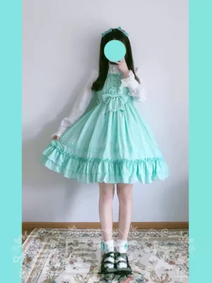 Water green multicolor lolita JSK dress front model shot with white long sleeve blouse and platform mary jane shoes