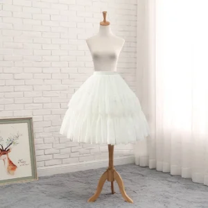 White adjustable hoop Lolita petticoat front three-quarter view on wooden mannequin, layered ruffled tulle A-line silhouette with lace trims