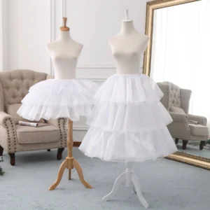 White adjustable tiered tulle petticoat for Lolita fashion displayed in cozy studio setting with full-length mirror reflection showing multi-layer hoop structure and bell-shaped silhouette