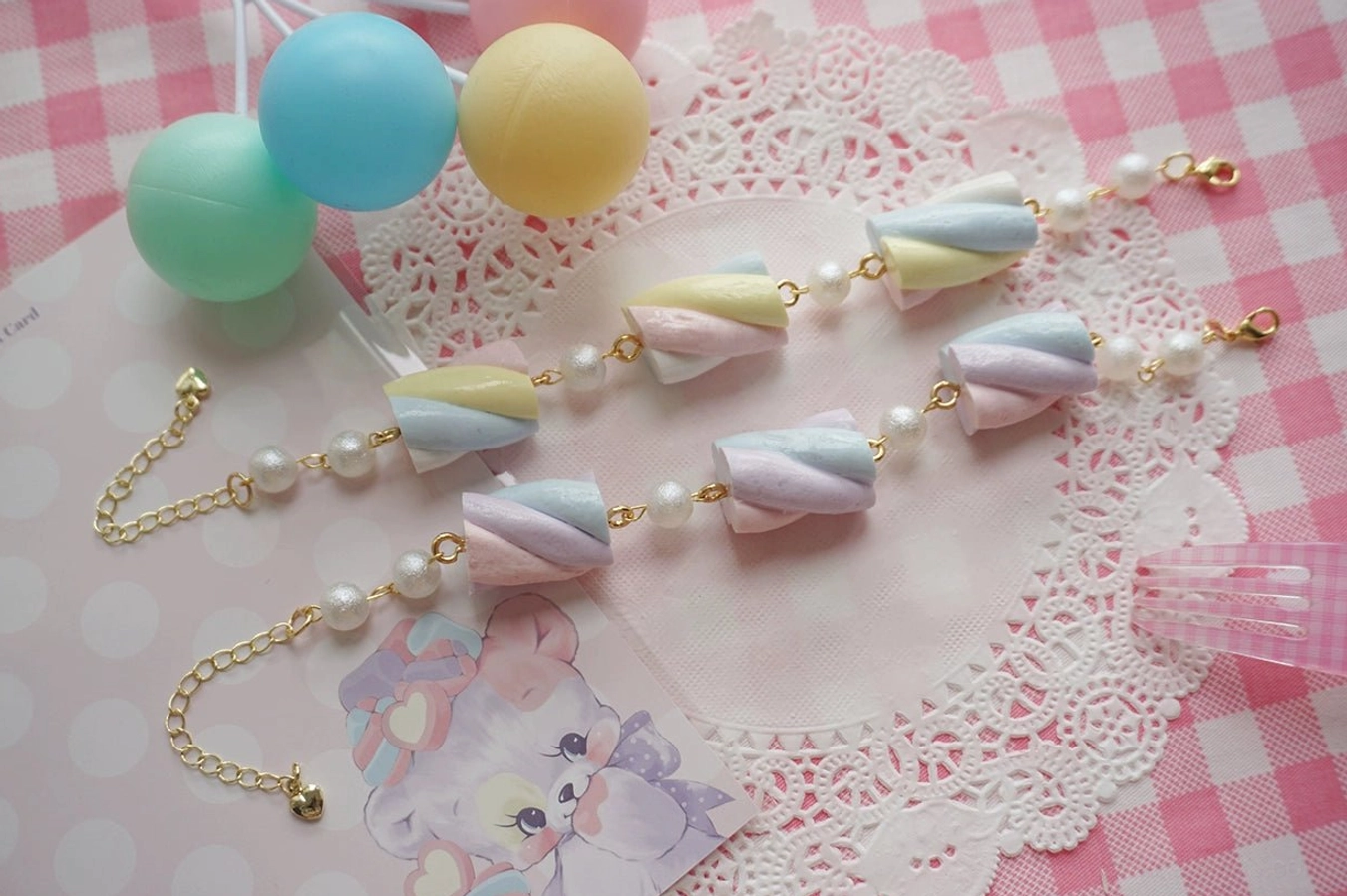 Sweet lolita cotton candy resin necklace variant in white and blue colorway featuring marshmallow charms with sky blue and pearl white tones, gold-tone hardware, and extension chain