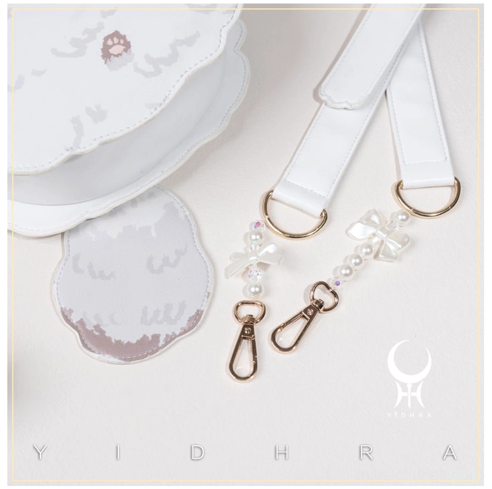 White kawaii cat shoulder bag with matching pearl bow charm accessories flat lay close-up, showing adjustable white PU strap and gold metal buckles