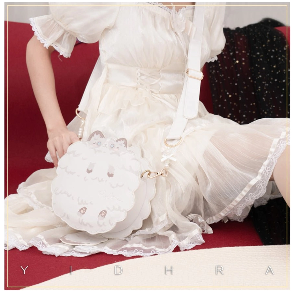 White kawaii cat shoulder bag side partial view worn with white ruffled lolita dress, featuring adjustable white shoulder strap and cute cat embroidery details