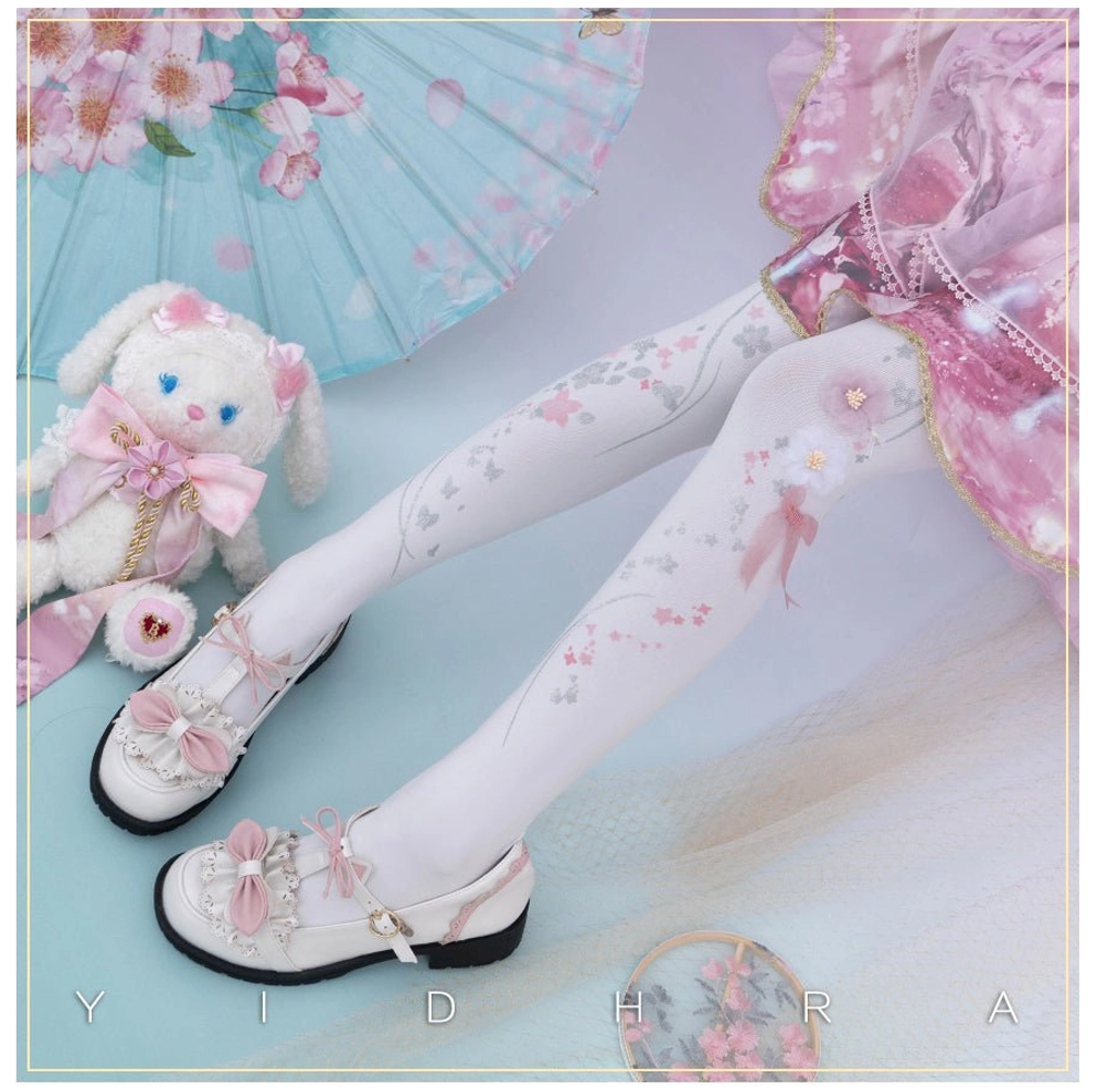 White cherry blossom qi lolita pantyhose 3d floral print with pink bow pom-poms worn with pink frilly lolita skirt and plush rabbit accessory