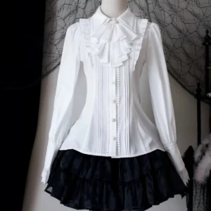White long-sleeve classic lolita blouse with fitted waist and front ruffle placket paired with black ruffled short skirt on mannequin