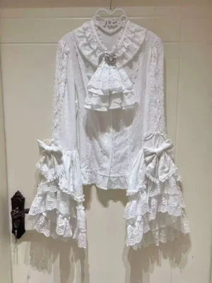 Pure white classic lolita blouse with bell sleeves and removable lace jabot featuring heart-shaped brooch displayed flat on hanger with button placket visible