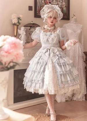 White plus-size classic lolita OP dress front view with short puff sleeves, multi-tiered lace ruffled skirt, large back statement bow, elegant royal lolita styling modeled in vintage fireplace room setting