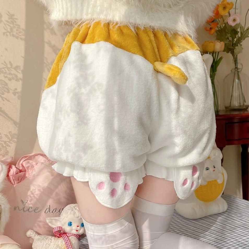 Flat lay product image of white corgi-themed velvet Lolita bloomers displaying full silhouette elastic waistband ruffled hem and design features