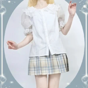 White cotton lolita blouse with lace-edged doll collar puff sleeves worn by model half body front view studio backdrop