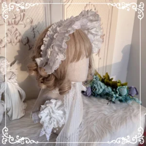 White cotton Lolita BNT bonnet hat with multi-layer ruffled lace trim and satin side bow, displayed from back view on mannequin with elegant Victorian backdrop and floral decor