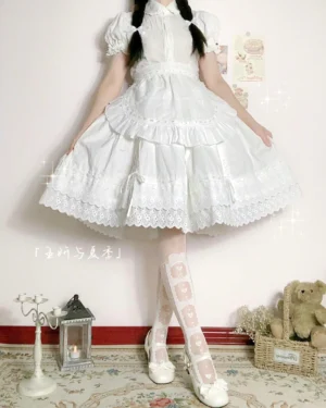 White cotton Lolita underskirt worn with matching outfit, full front view showing gathered ruffled skirt with embroidered lace hem and satin ribbon details, styled with bow-patterned sheer stockings