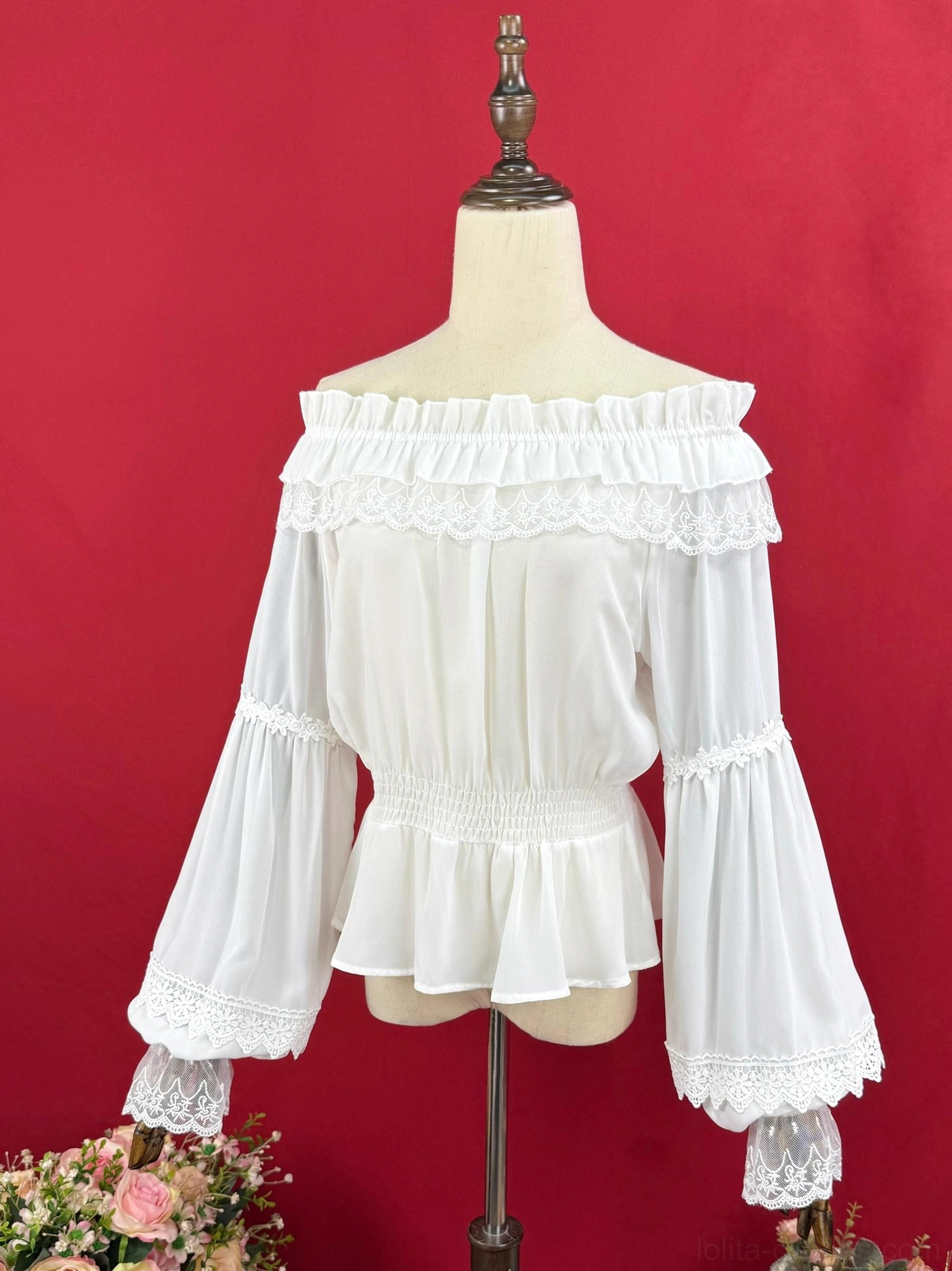 White double-ruffled off-shoulder Lolita blouse with lace-trimmed bell sleeves elasticated waist and peplum hem front view