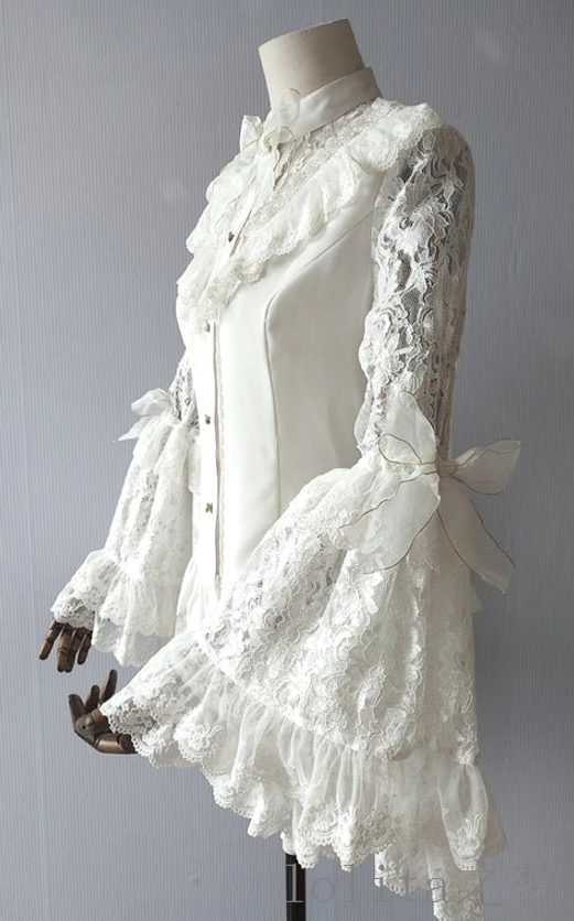 Right side full view of white Lolita lace blouse on dress form showing lace-trimmed stand collar, fitted body silhouette, lace trumpet sleeves with ruffled hem and side bows