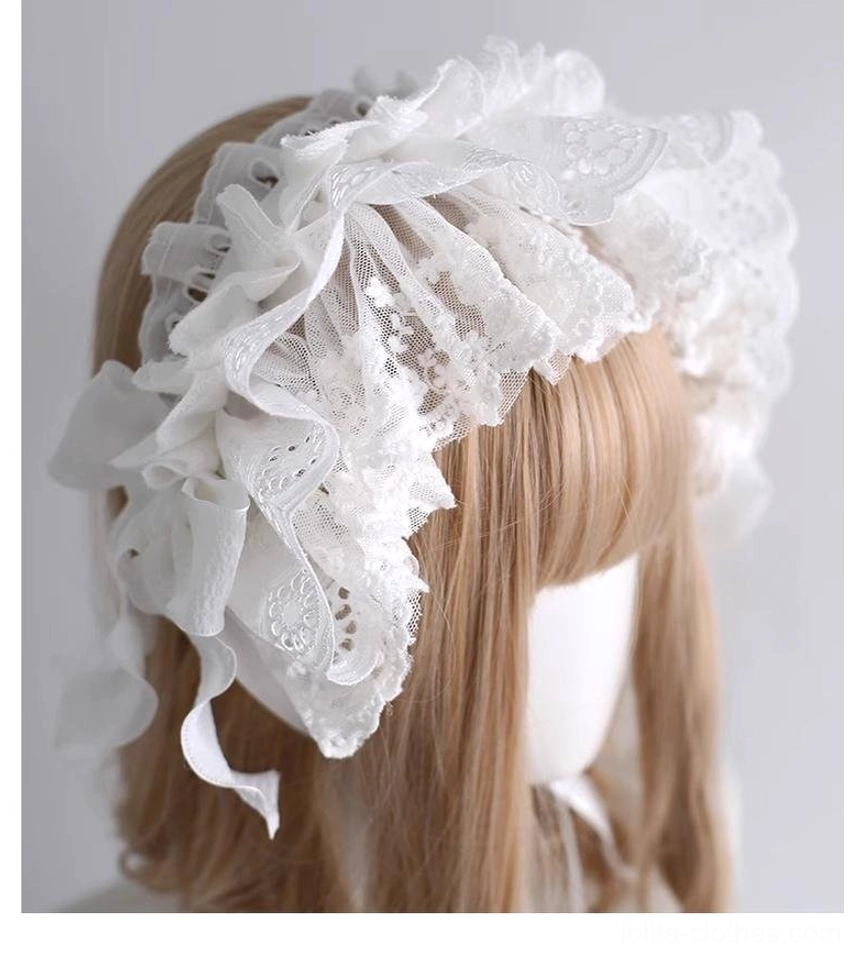 Back left three-quarter perspective of white embroidered lace lolita hair accessory featuring layered ruffled lace bow and embroidered panels