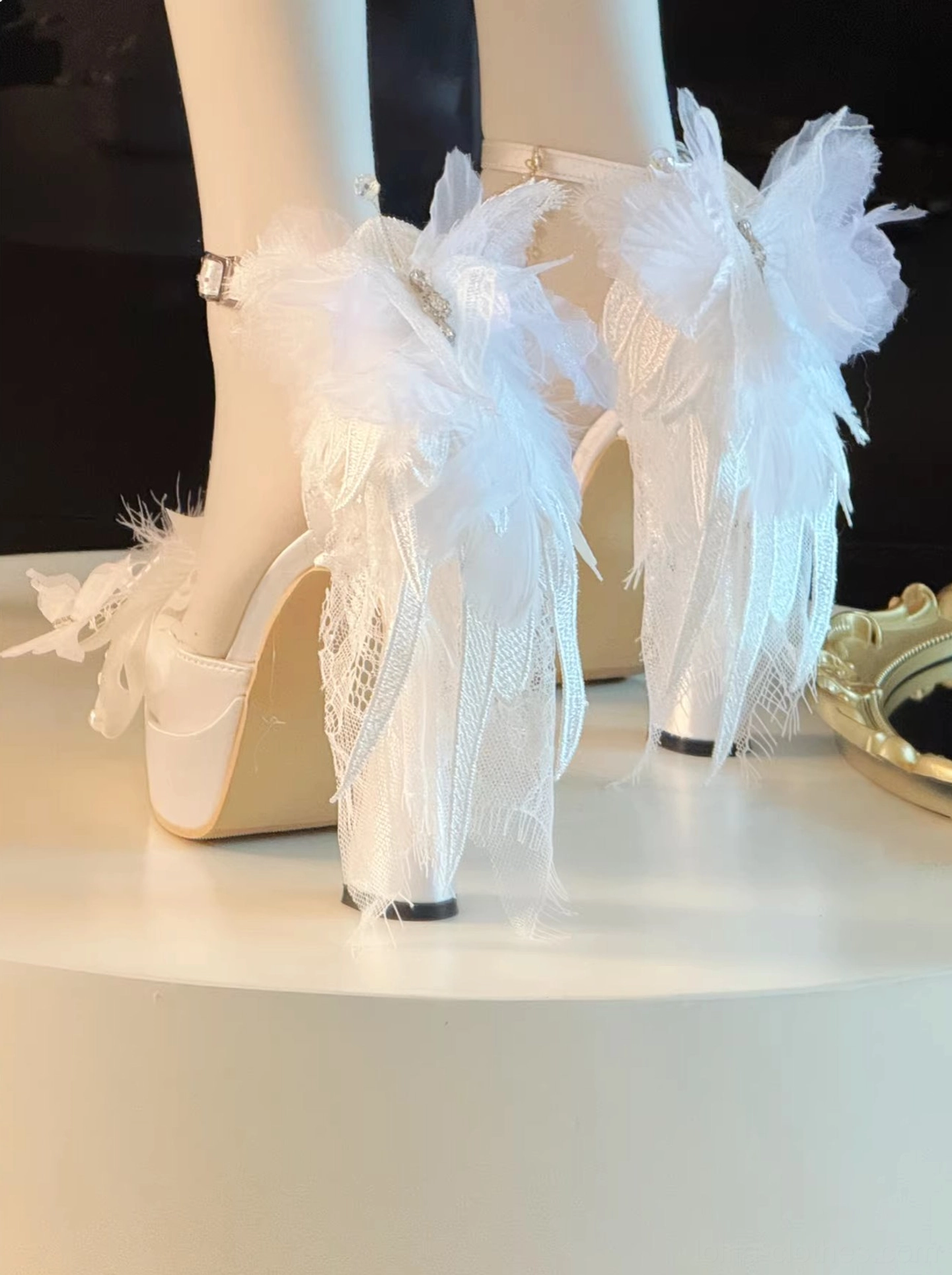 White fluffy feather lolita high heel shoes with long feather trims on heel, lace mesh upper, adjustable ankle buckle strap, chunky block heel, round display table setting