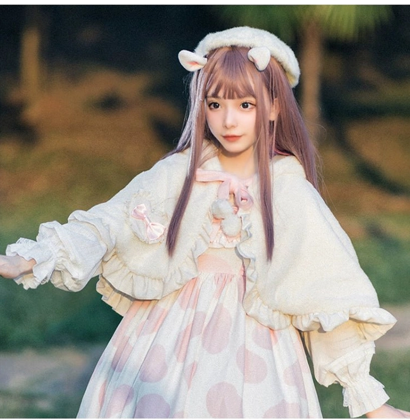 White fluffy rabbit ear D-style Lolita cape shawl on model with purple hair wearing cat-ear beret and pink polka dot dress in park