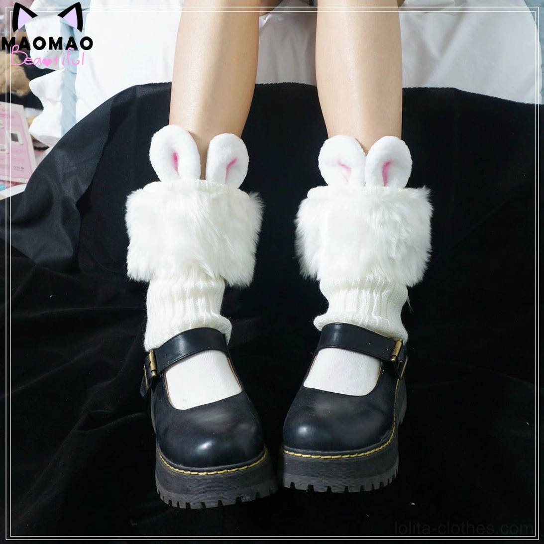 White fluffy rabbit ear lolita leg warmers overhead view paired with black Mary Jane shoes and white short socks showcase twisted knit fabric and 3D bunny ear decorations