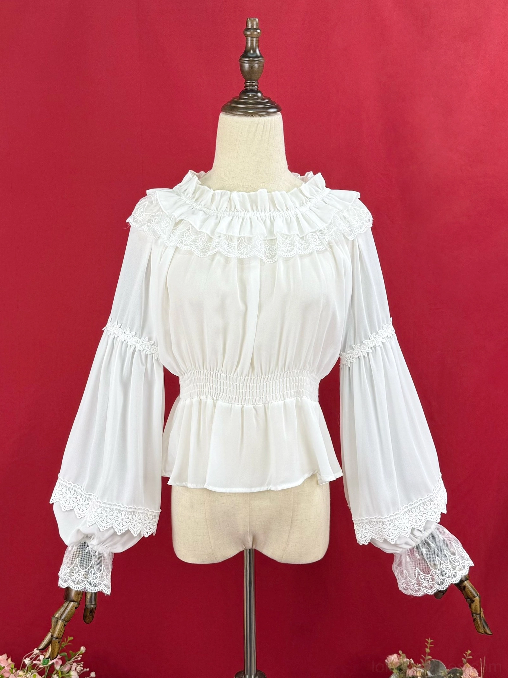 White frilled stand collar Lolita blouse with lace-trimmed bell sleeves and elasticated peplum waist on dress form front view