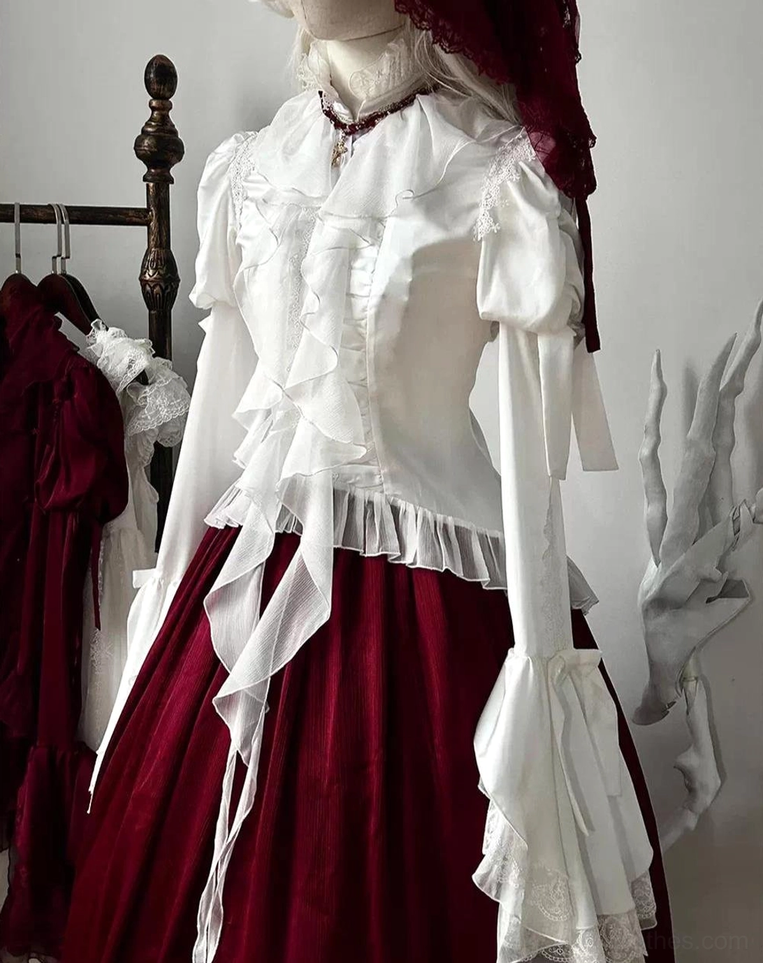 White gothic lolita blouse with hime sleeves and layered ruffle collar, mannequin display showing translucent satin chiffon construction with lace-trimmed details
