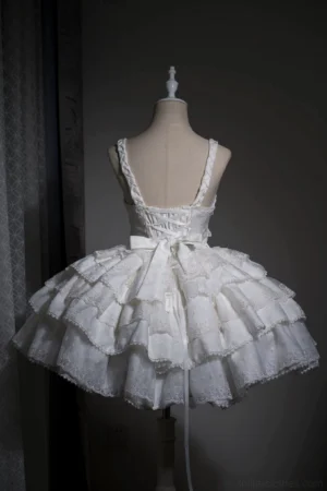 White Gothic Lolita JSK Dress back view displaying lace-up corset back spaghetti straps and multi-layered ruffled hem with back bow accent