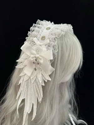 White Gothic Lolita lace headdress with silver cross charm and embroidered wing decoration, side profile view on mannequin, showcasing delicate lace construction and white satin bow details with decorative buttons
