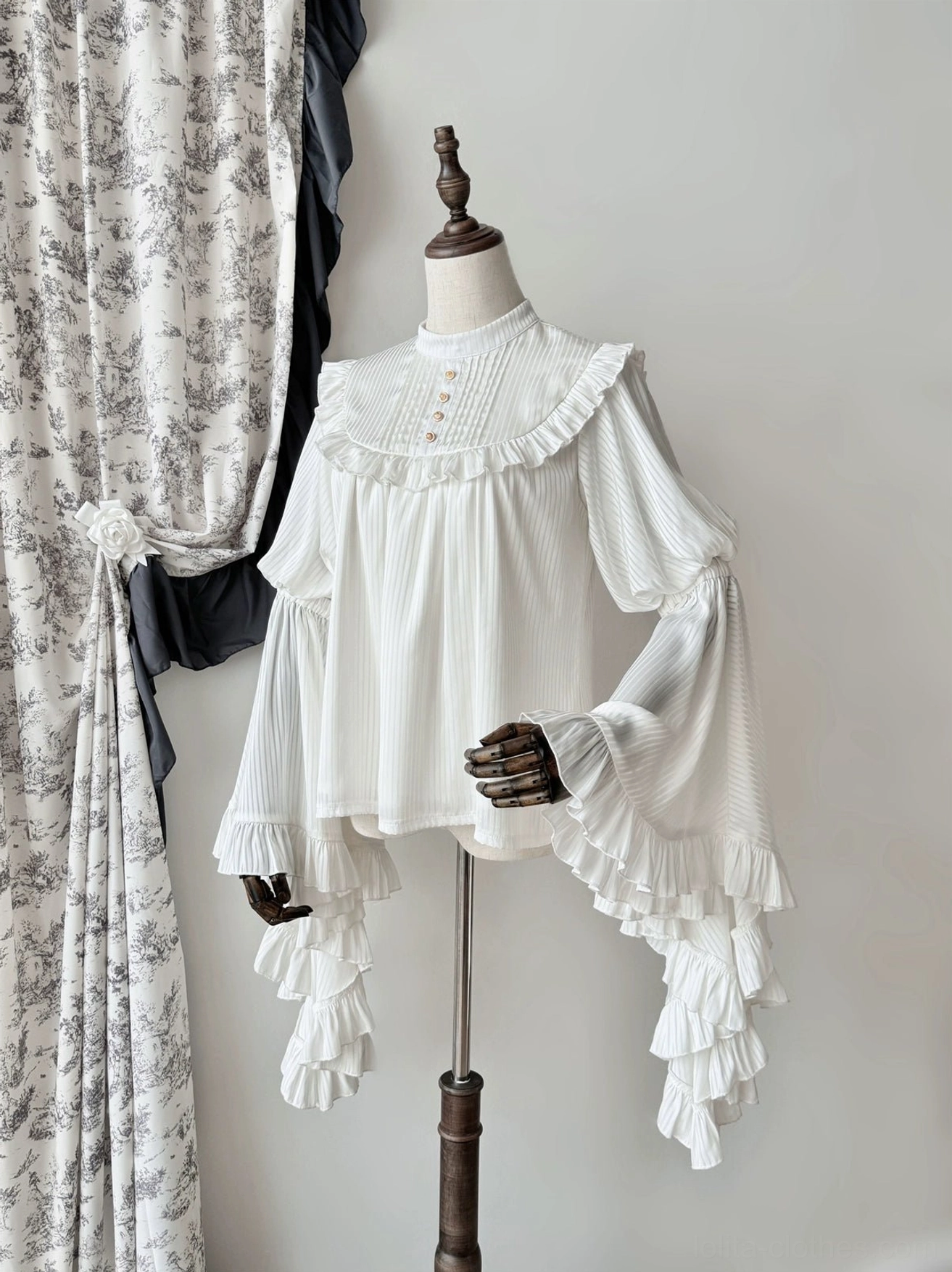 White gothic lolita princess sleeve blouse front full view with stand collar, ruffled yoke, and long ruffled flare sleeves on dress form