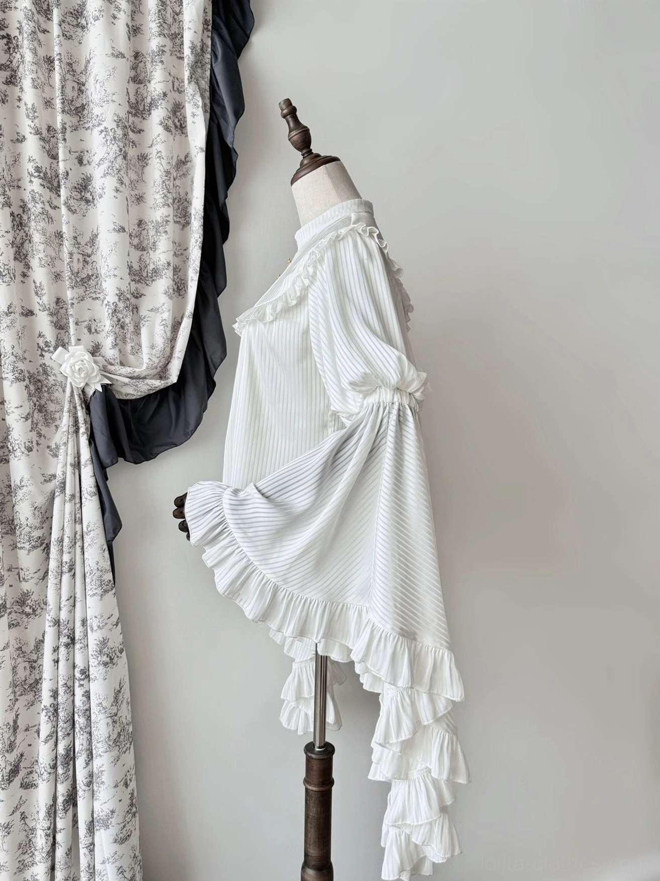 White gothic lolita blouse right side view showing layered ruffled sleeve hems, pleated vertical stripe fabric, and ruffled shoulder trim