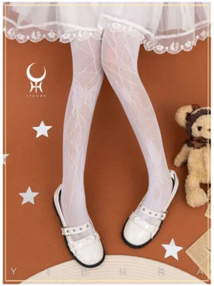 White gothic lolita spider butterfly net pantyhose with delicate jacquard pattern worn with white lace-trimmed skirt and studded mary jane shoes on warm terracotta background