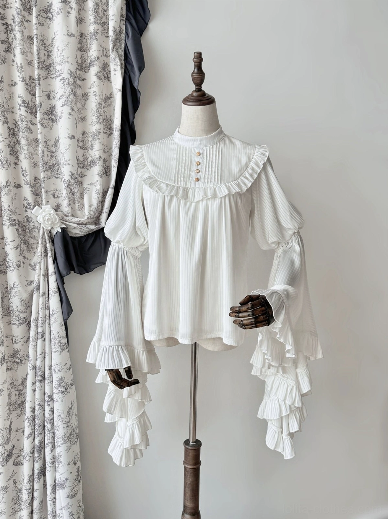 White gothic lolita blouse three-quarter front view with pleated sheer fabric, front button placket, and layered flared ruffled cuffs