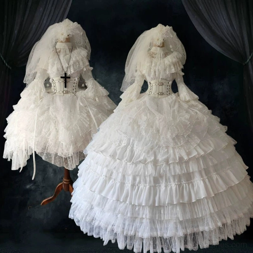 White Gothic Wedding Lolita One-Piece Dress long style front view displayed on mannequin with layered tulle ruffled skirt and lace details against dark velvet backdrop