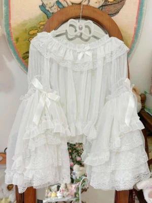 Ethereal white sheer chiffon hime sleeve off-shoulder lolita blouse hanging on wooden bow hanger, displaying tiered lace ruffled bell sleeves and intricate lace collar detail