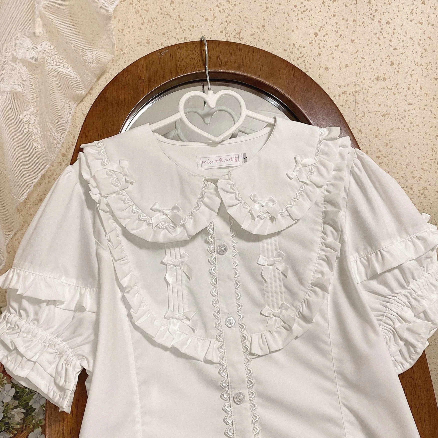 Pure white short sleeve lolita blouse with double layer ruffled doll collar tiny satin bows and layered sleeves hanging on heart hanger