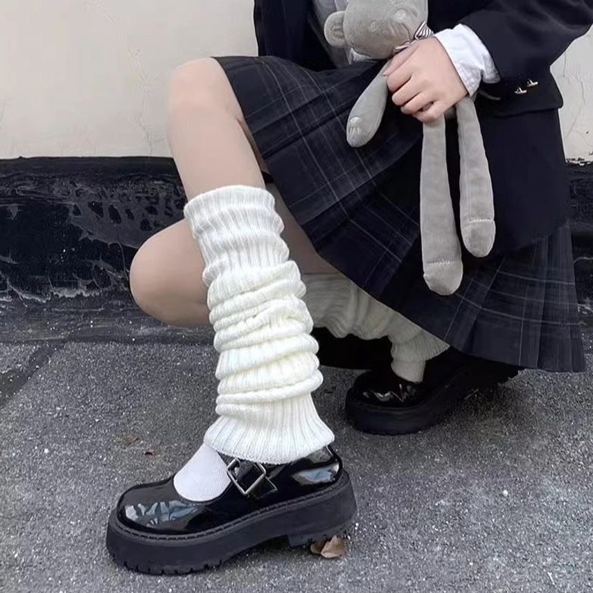 White knitted lolita leg warmers close-up side view oversized slouch fit thick ribbed texture mary jane shoes