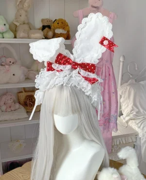 White lace bunny ear lolita headband with red polka dot bow displayed on silver wig mannequin showing full front view details