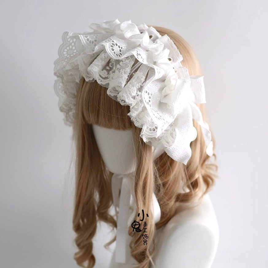 Side three-quarter view of white embroidered lace lolita headdress showing oversized bow and multi-layered ruffled lace trim on mannequin