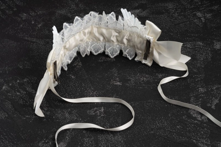 Gothic lolita white lace angel wings hairband product detail shot showing lace frilling and satin bow embellishments, professional studio lighting