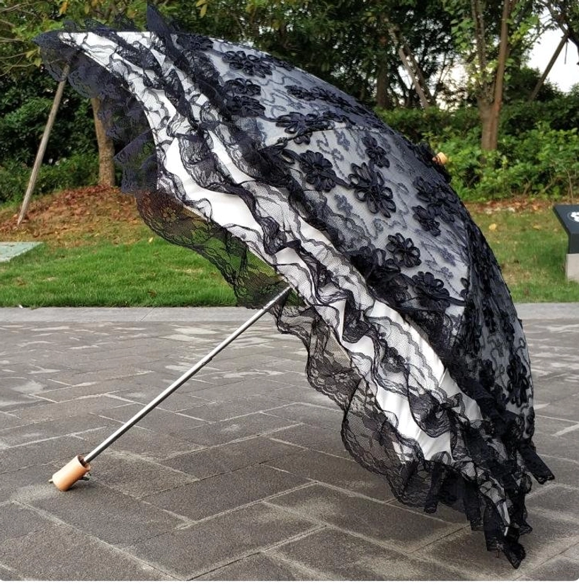 White lace Lolita parasol canopy fully open displaying multi-layered ruffled construction and comprehensive lace coverage for elegant sun protection
