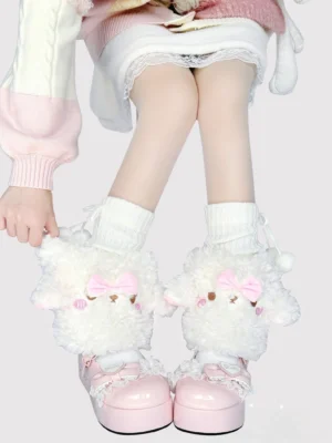 White fluffy lamb-shaped kawaii lolita leg warmers with pink bow worn by model in pink-spliced sweater white lace skirt and pink platform Mary Janes front view