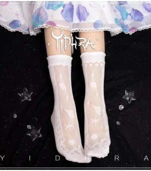 Plain white knitted voile Lolita ankle socks with embossed marine shell and star patterns, featuring ruffled lace trim at top, overhead shot on dark starry background