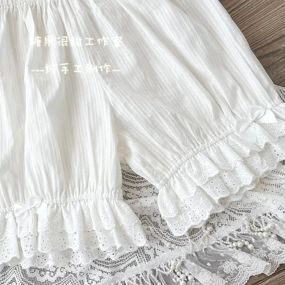 Styling showcase of white premium lolita cotton bloomers with elastic version demonstrating versatility, modest leg coverage for authentic lolita coordinate, ruffled embroidered lace hem detail visible beneath skirt, and practical all-day comfort wearability
