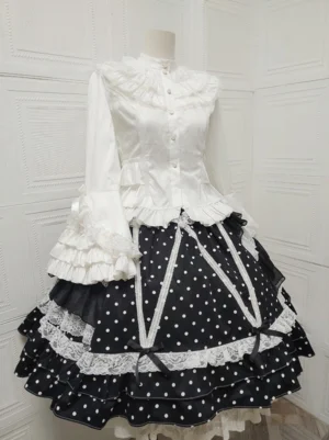 White ruffled stand collar classic lolita blouse with button placket and flared trumpet sleeves coordinated with black polka dot skirt white lace layers front view
