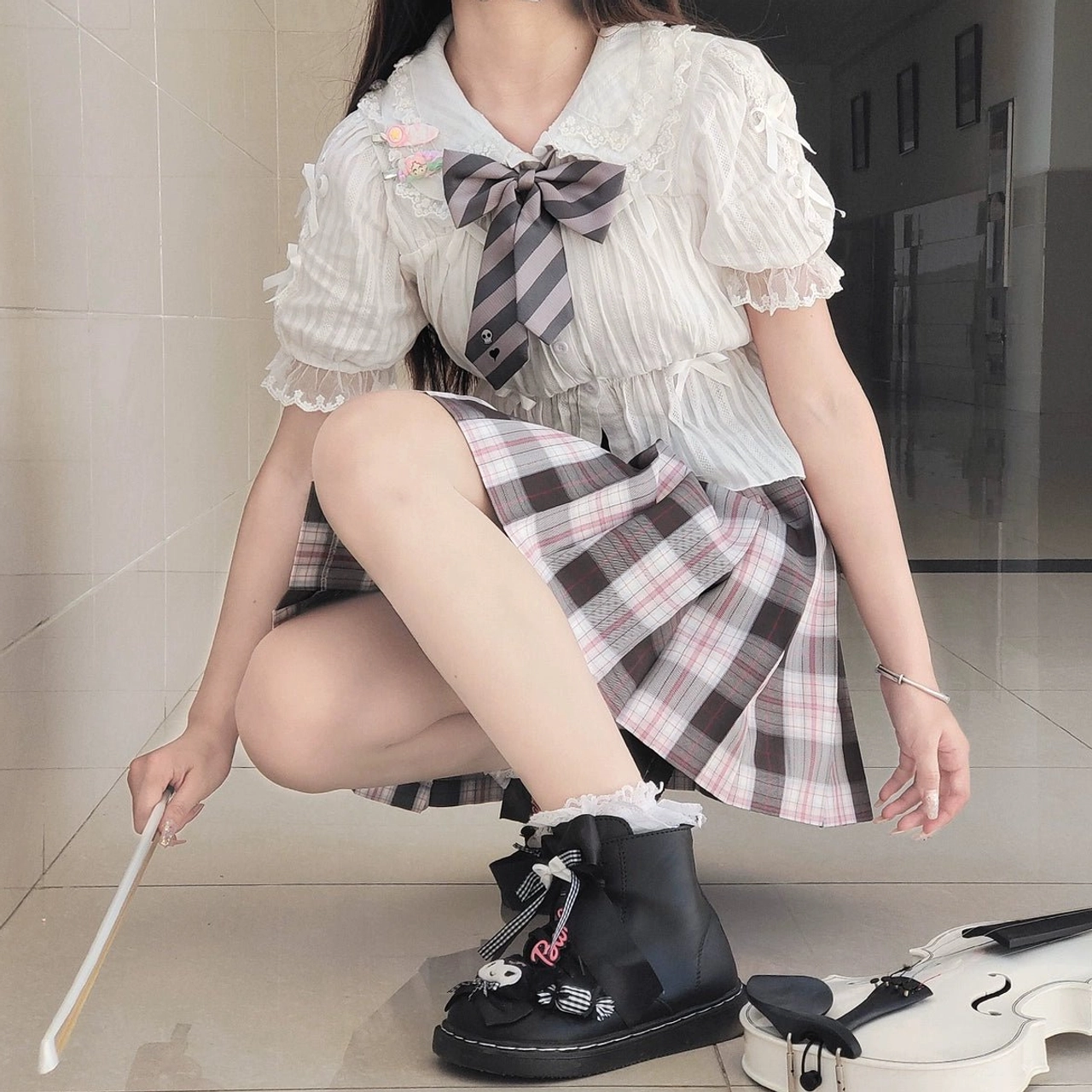 White lolita blouse brown plaid mini skirt coordinate squat pose female model black lolita boots bow