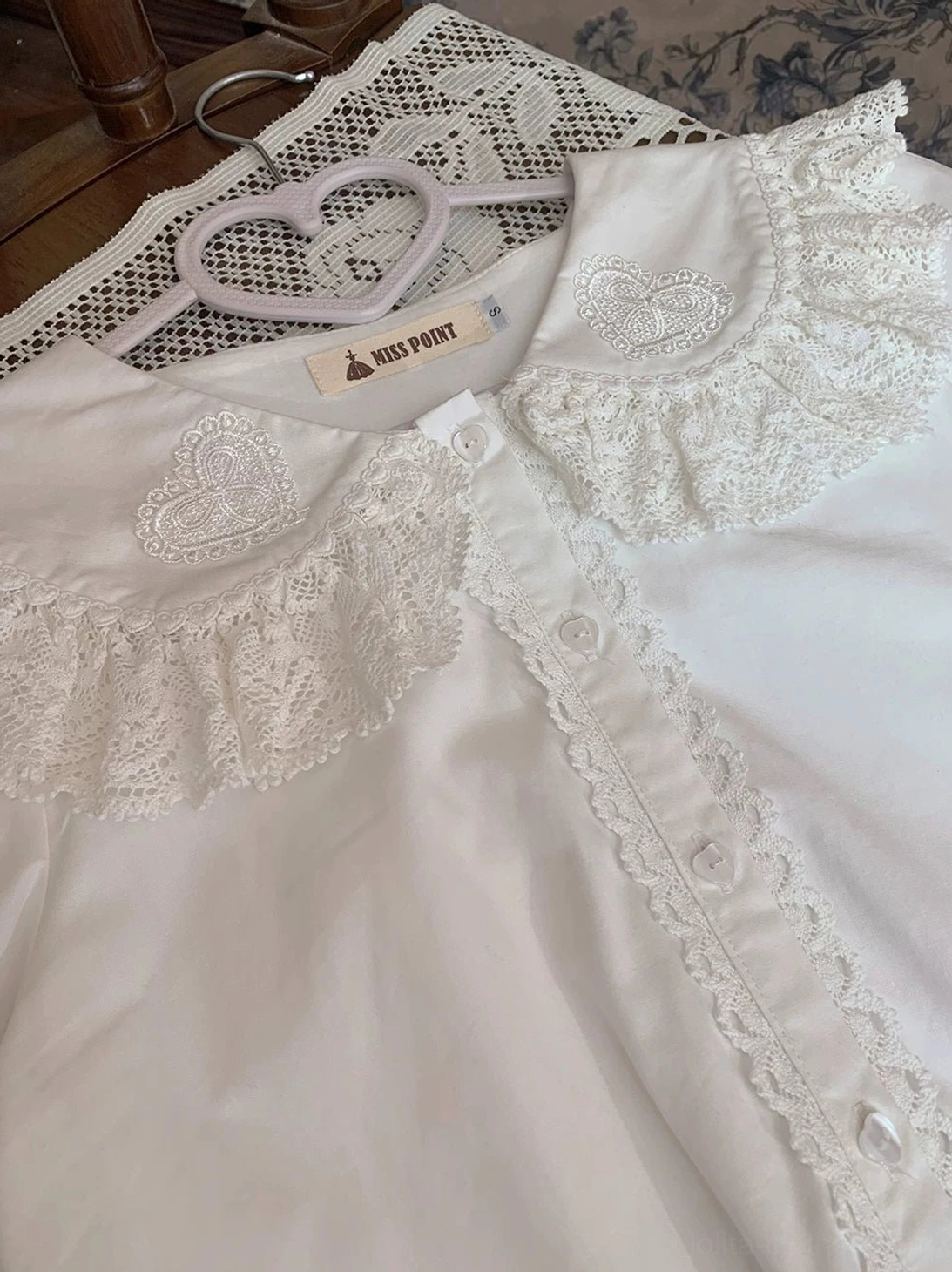 close-up detail bunny ear collar shoulder area lolita blouse ruffled lace heart embroidery intricate trimmings