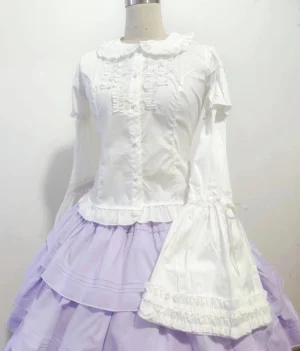 White detachable-sleeve sweet lolita blouse with peter pan collar and ruffled front placket, shown on dress form with extended bell sleeves and lace-trimmed cuffs, paired with light purple tiered skirt