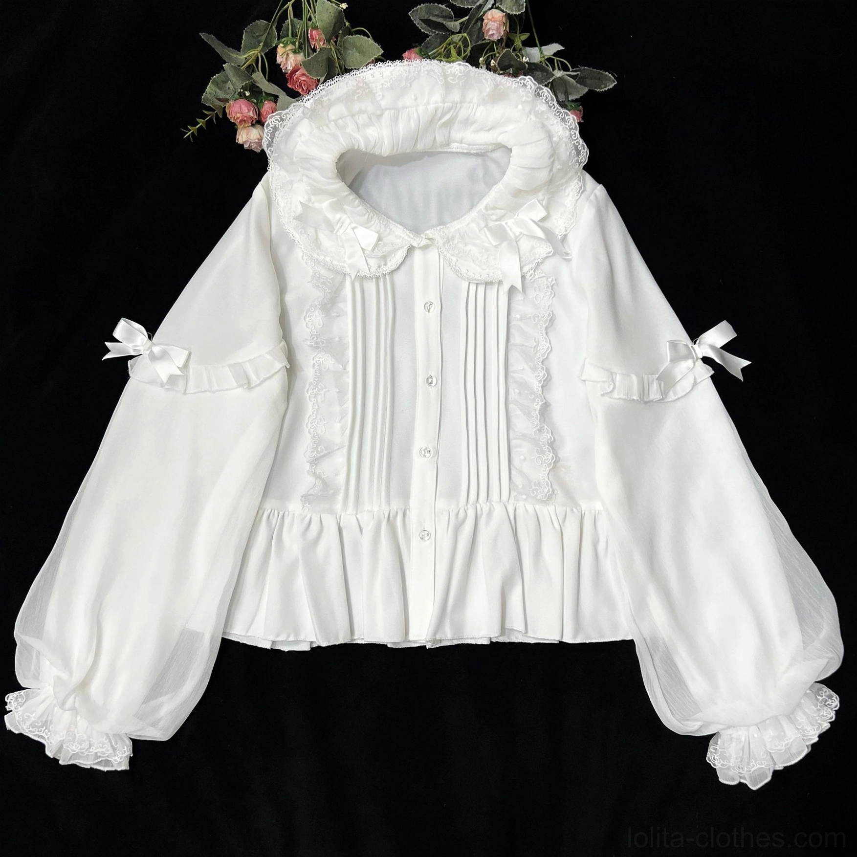 White Lolita blouse with double ruffled Peter Pan collar, front lace pintuck details, decorative sleeve bows and sheer puff cuffs - flat overhead display with floral background